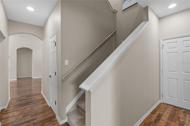 7626 Double Pine Dr, Sarasota, FL 34240 - hall with wood finished floors, arched walkways, baseboards, stairway, and recessed lighting