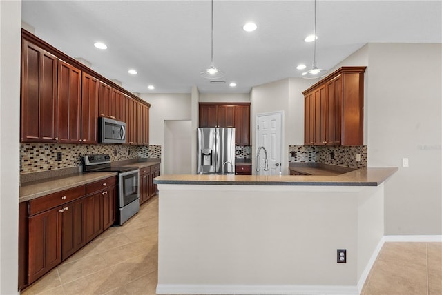 7626 Double Pine Dr, Sarasota, FL 34240 - kitchen with appliances with stainless steel finishes, a peninsula, light tile patterned floors, backsplash, and recessed lighting