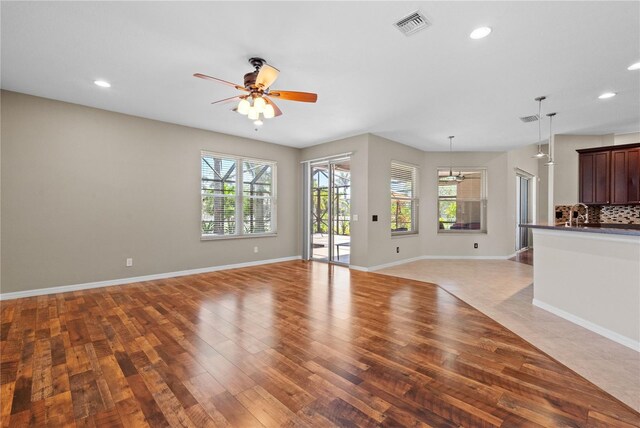 7626 Double Pine Dr, Sarasota, FL 34240 - unfurnished living room featuring wood finished floors, recessed lighting, ceiling fan, and baseboards