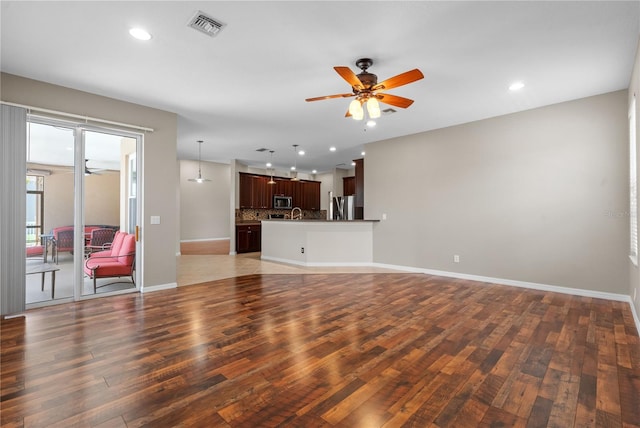 7626 Double Pine Dr, Sarasota, FL 34240 - unfurnished living room with wood finished floors, ceiling fan, recessed lighting, and baseboards