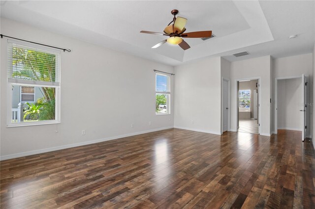 7626 Double Pine Dr, Sarasota, FL 34240 - spare room with dark wood-style floors, a tray ceiling, a ceiling fan, and baseboards