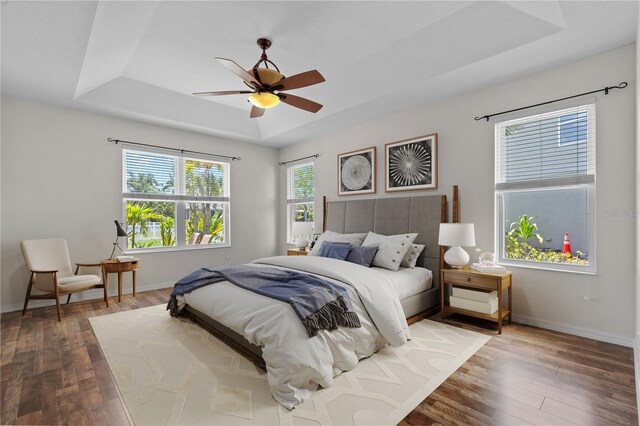 7626 Double Pine Dr, Sarasota, FL 34240 - bedroom with a raised ceiling, hardwood / wood-style floors, baseboards, and ceiling fan