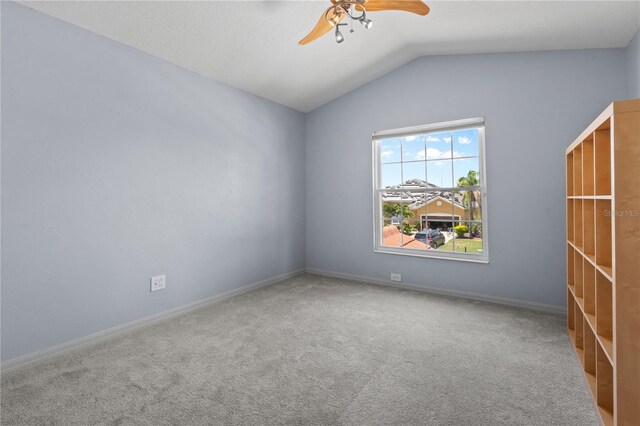 7626 Double Pine Dr, Sarasota, FL 34240 - empty room with ceiling fan, lofted ceiling, carpet flooring, and baseboards
