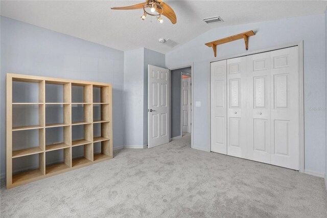 7626 Double Pine Dr, Sarasota, FL 34240 - unfurnished bedroom featuring vaulted ceiling, carpet floors, a closet, baseboards, and ceiling fan