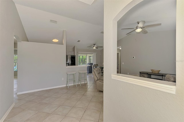 2759 Starview Ave, North Port, FL 34288 - hallway featuring vaulted ceiling, tile patterned flooring, arched walkways, and baseboards