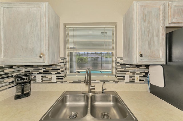 2759 Starview Ave, North Port, FL 34288 - kitchen with a sink, light countertops, and backsplash