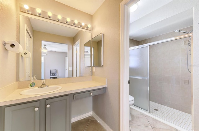 2759 Starview Ave, North Port, FL 34288 - bathroom featuring tile patterned floors, toilet, a stall shower, a ceiling fan, and vanity