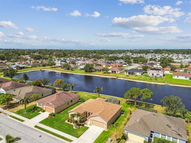 aerial view of residential area featuring a large body of water
