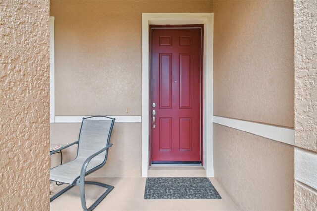 entrance to property with stucco siding