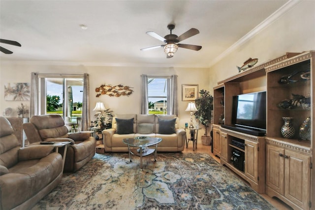 living area with a ceiling fan and crown molding
