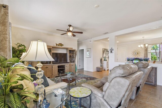 living area featuring ceiling fan, a chandelier, crown molding, and baseboards