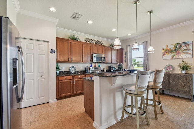 kitchen featuring stainless steel appliances, brown cabinetry, a breakfast bar area, crown molding, and dark stone countertops
