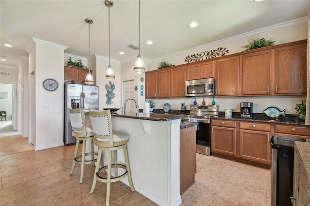 kitchen with appliances with stainless steel finishes, brown cabinets, a breakfast bar, ornamental molding, and recessed lighting