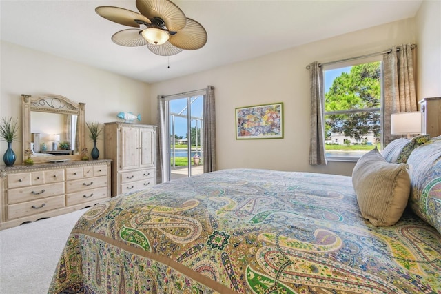 carpeted bedroom with access to outside and a ceiling fan