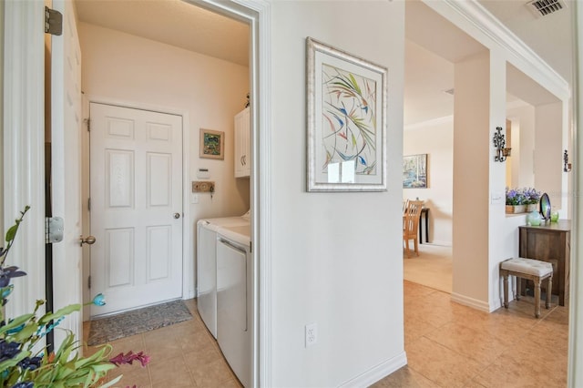 laundry area with cabinet space, independent washer and dryer, light tile patterned floors, and baseboards