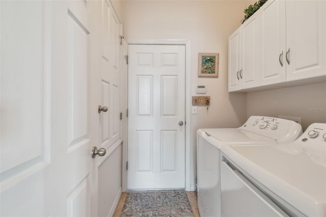 laundry room featuring independent washer and dryer, cabinet space, light tile patterned flooring, and baseboards
