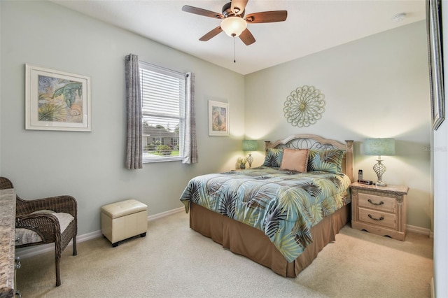bedroom with light carpet, baseboards, and a ceiling fan