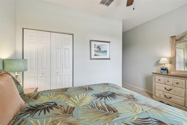 bedroom with a closet, carpet flooring, baseboards, and a ceiling fan