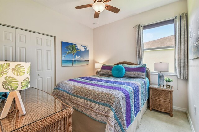 bedroom with a closet, carpet flooring, ceiling fan, and baseboards