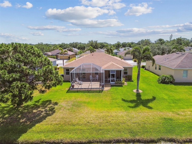 back of property featuring a patio, a lawn, a lanai, and a residential view