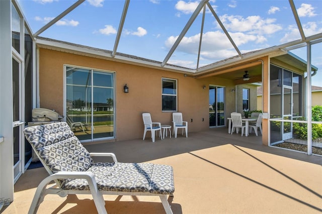 back of property featuring stucco siding, a patio area, and a lanai