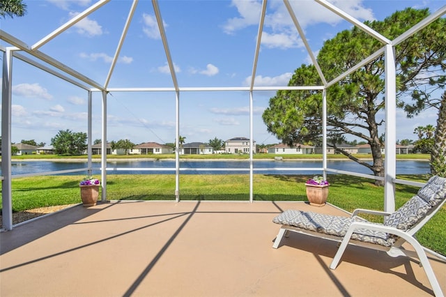 sunroom with a water view and a residential view