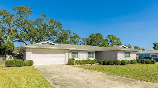 single story home featuring concrete driveway and an attached garage