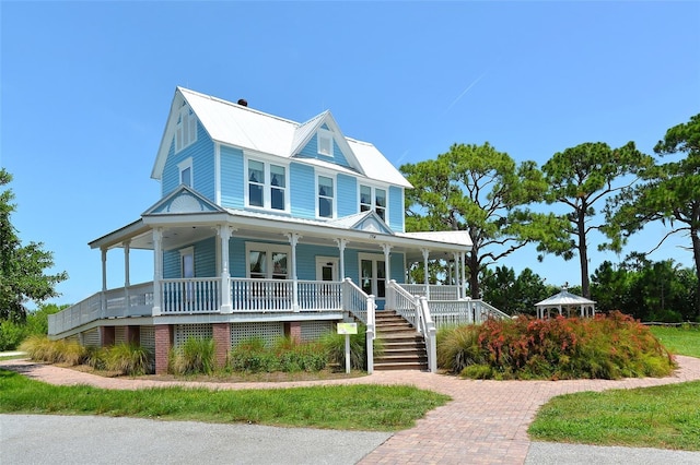 5706 10th Avenue Dr W, Bradenton, FL 34209 - view of front of property with a porch, stairs, and metal roof