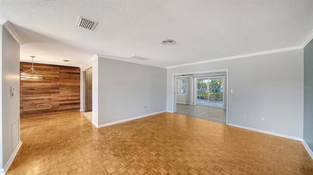 5706 10th Avenue Dr W, Bradenton, FL 34209 - spare room featuring wooden walls, baseboards, a textured ceiling, and ornamental molding