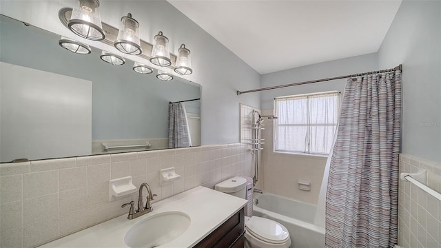 5706 10th Avenue Dr W, Bradenton, FL 34209 - bathroom with tile walls, vanity, shower / bath combo with shower curtain, toilet, and wainscoting