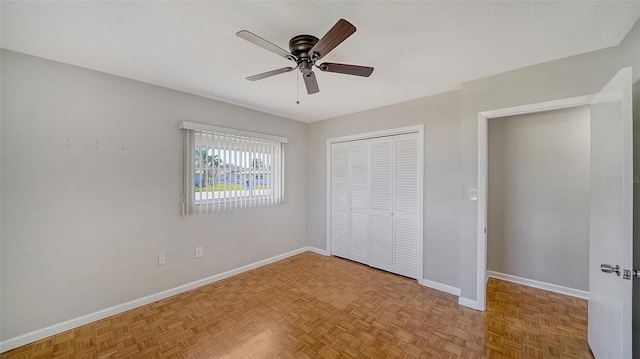 5706 10th Avenue Dr W, Bradenton, FL 34209 - unfurnished bedroom featuring a closet, baseboards, ceiling fan, and a textured ceiling