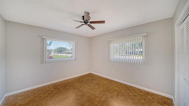 5706 10th Avenue Dr W, Bradenton, FL 34209 - unfurnished bedroom with baseboards, a textured ceiling, a closet, and ceiling fan