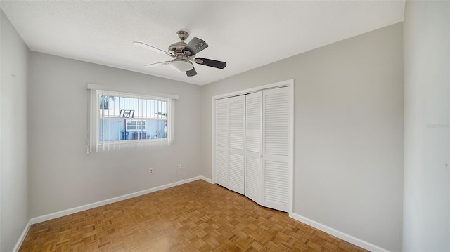 5706 10th Avenue Dr W, Bradenton, FL 34209 - unfurnished bedroom with baseboards, a closet, ceiling fan, and a textured ceiling