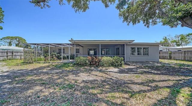 5706 10th Avenue Dr W, Bradenton, FL 34209 - rear view of property with a sunroom