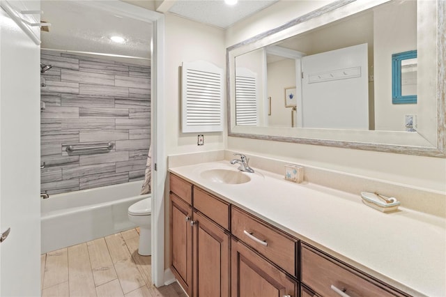 bathroom with toilet, vanity, recessed lighting, and shower / tub combination