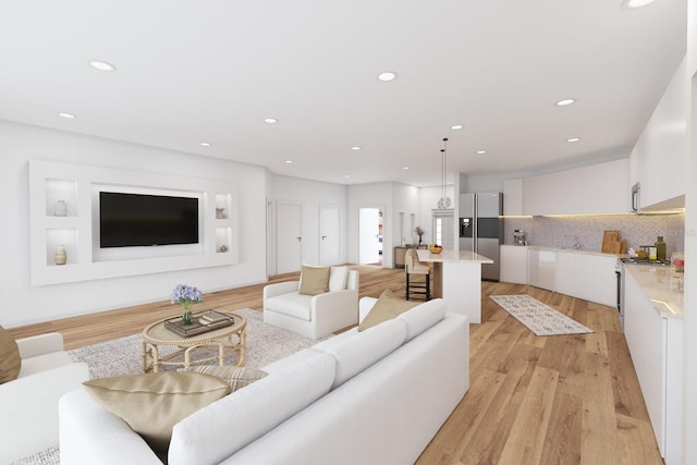 living area featuring light wood finished floors and recessed lighting