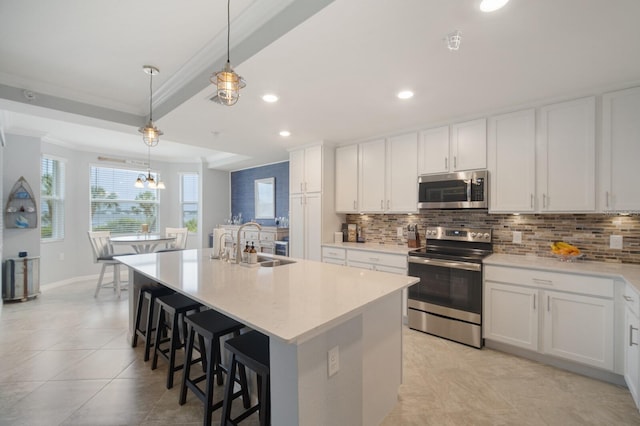 910 Tidewater Shores Loop Unit 103, Bradenton, FL 34208 - kitchen featuring stainless steel appliances, a sink, tasteful backsplash, white cabinetry, and recessed lighting