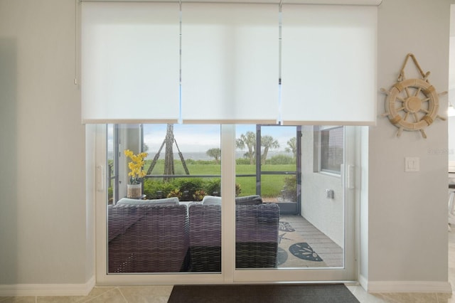 910 Tidewater Shores Loop Unit 103, Bradenton, FL 34208 - doorway featuring tile patterned flooring and baseboards