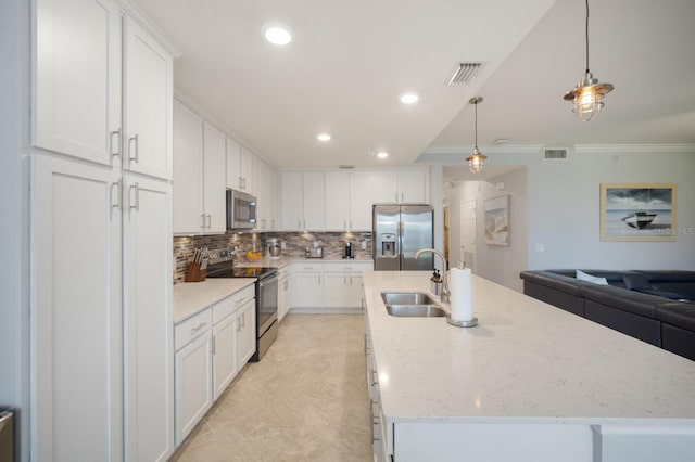 910 Tidewater Shores Loop Unit 103, Bradenton, FL 34208 - kitchen with appliances with stainless steel finishes, a sink, crown molding, backsplash, and white cabinets