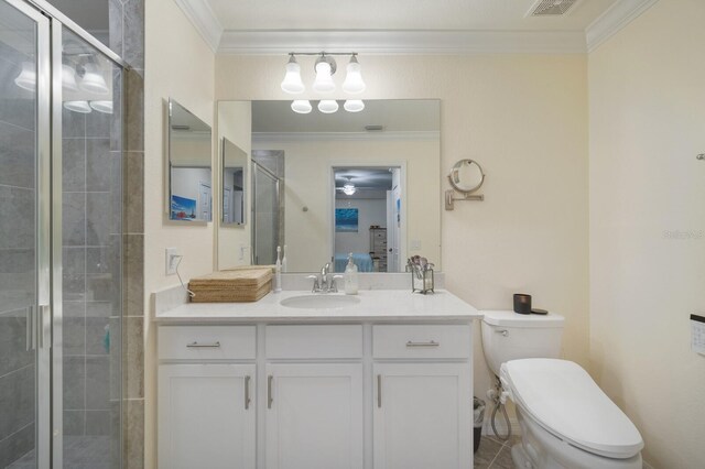 910 Tidewater Shores Loop Unit 103, Bradenton, FL 34208 - ensuite bathroom featuring ornamental molding, a stall shower, vanity, and toilet