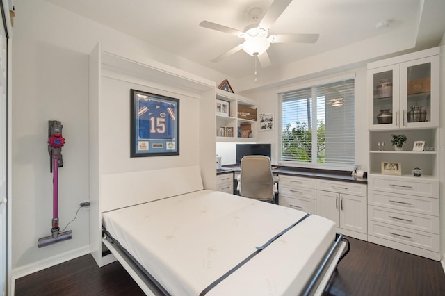 910 Tidewater Shores Loop Unit 103, Bradenton, FL 34208 - bedroom with dark wood-style floors, an office area, a ceiling fan, and baseboards