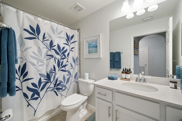 910 Tidewater Shores Loop Unit 103, Bradenton, FL 34208 - bathroom with toilet, vanity, curtained shower, and tile patterned floors