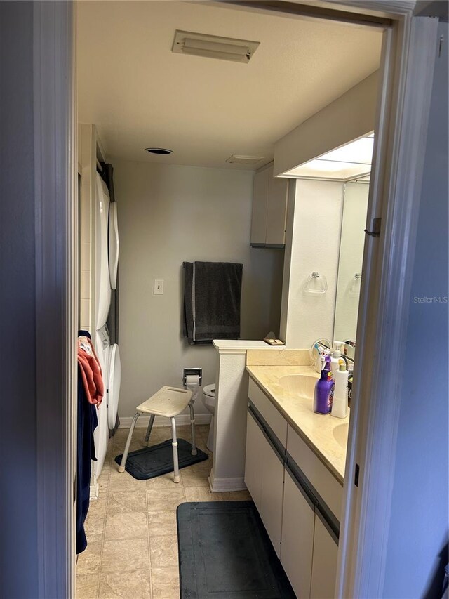full bath with toilet and double vanity