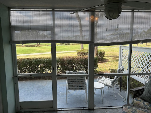 sunroom featuring a ceiling fan