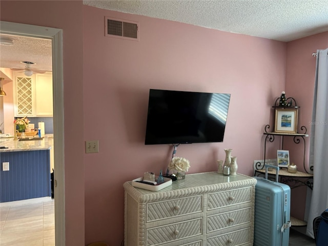 detailed view of a textured ceiling and a ceiling fan