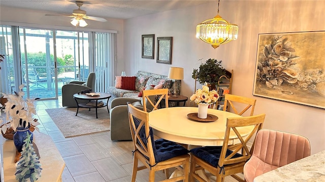 433 Cerromar Ln Unit 331, Venice, FL 34293 - dining room featuring a ceiling fan, a chandelier, and light tile patterned floors
