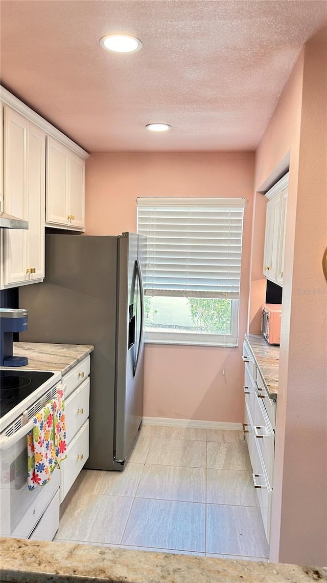 433 Cerromar Ln Unit 331, Venice, FL 34293 - kitchen with white range with electric cooktop, white cabinetry, baseboards, recessed lighting, and light stone counters