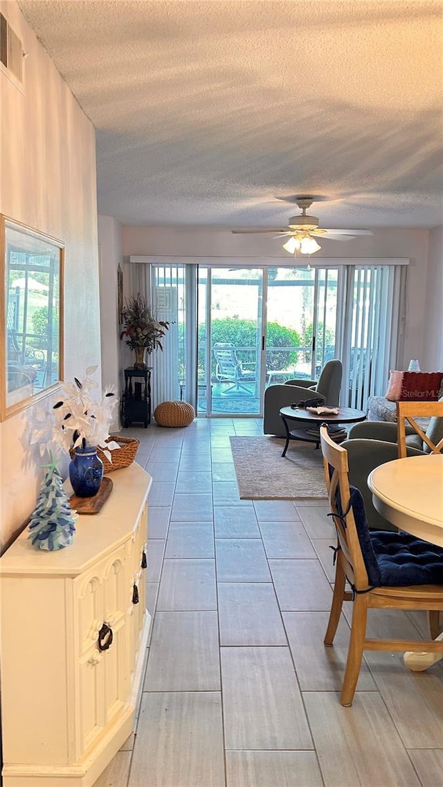 433 Cerromar Ln Unit 331, Venice, FL 34293 - living area featuring a textured ceiling, a ceiling fan, and light tile patterned floors