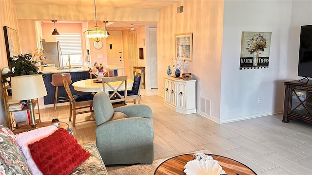 433 Cerromar Ln Unit 331, Venice, FL 34293 - living room with a chandelier and baseboards