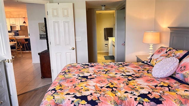 433 Cerromar Ln Unit 331, Venice, FL 34293 - bedroom with wood finished floors and freestanding refrigerator